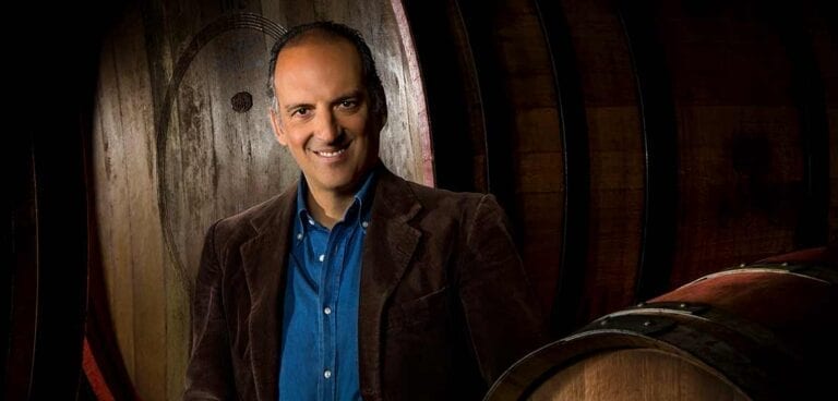 Wine producer Giovanni Folonari standing amidst barrels in a wine cellar in Tuscany, Italy. Copyright Angelo Trani