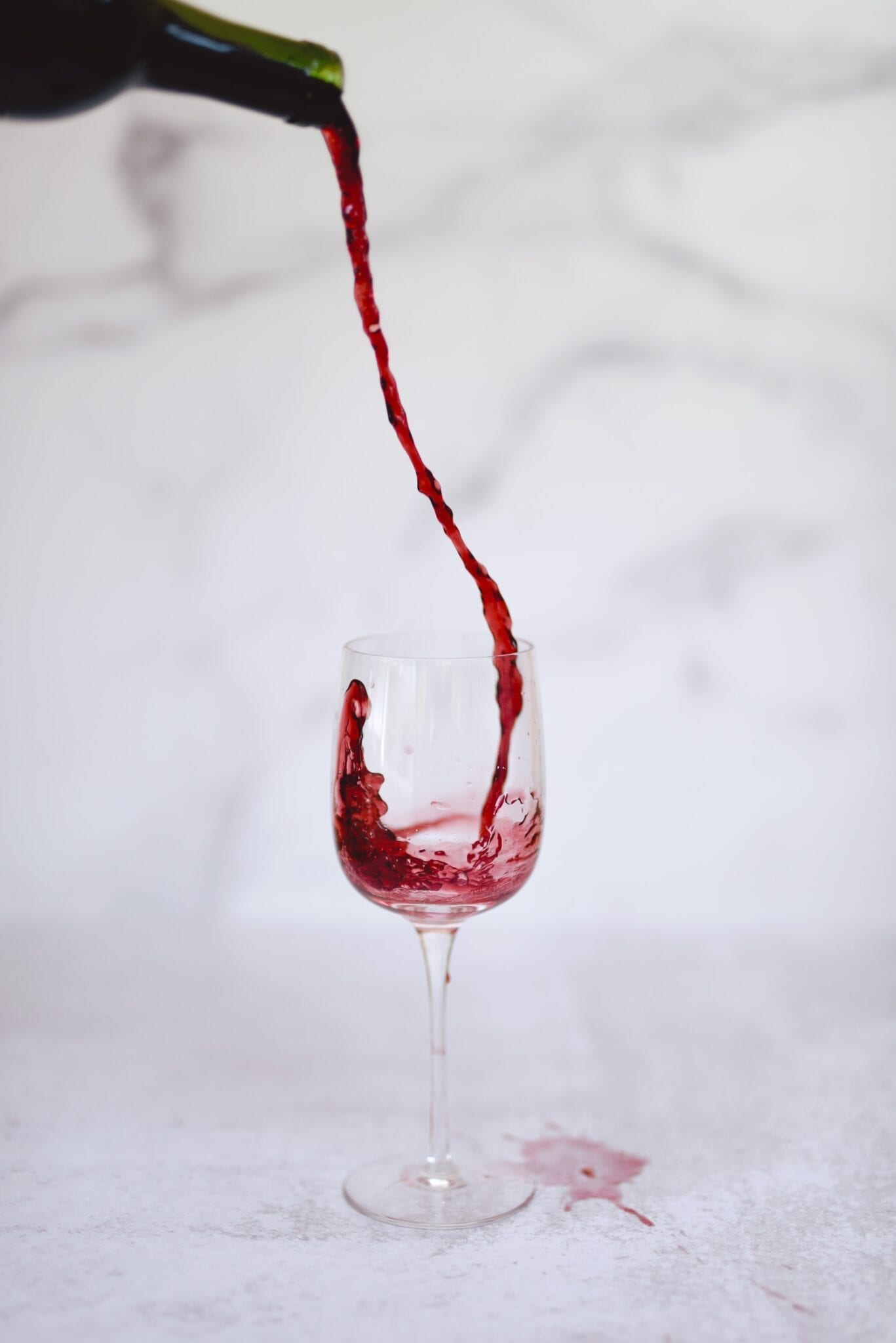 Pouring red wine. Photo by Christian Bowen, Unsplash