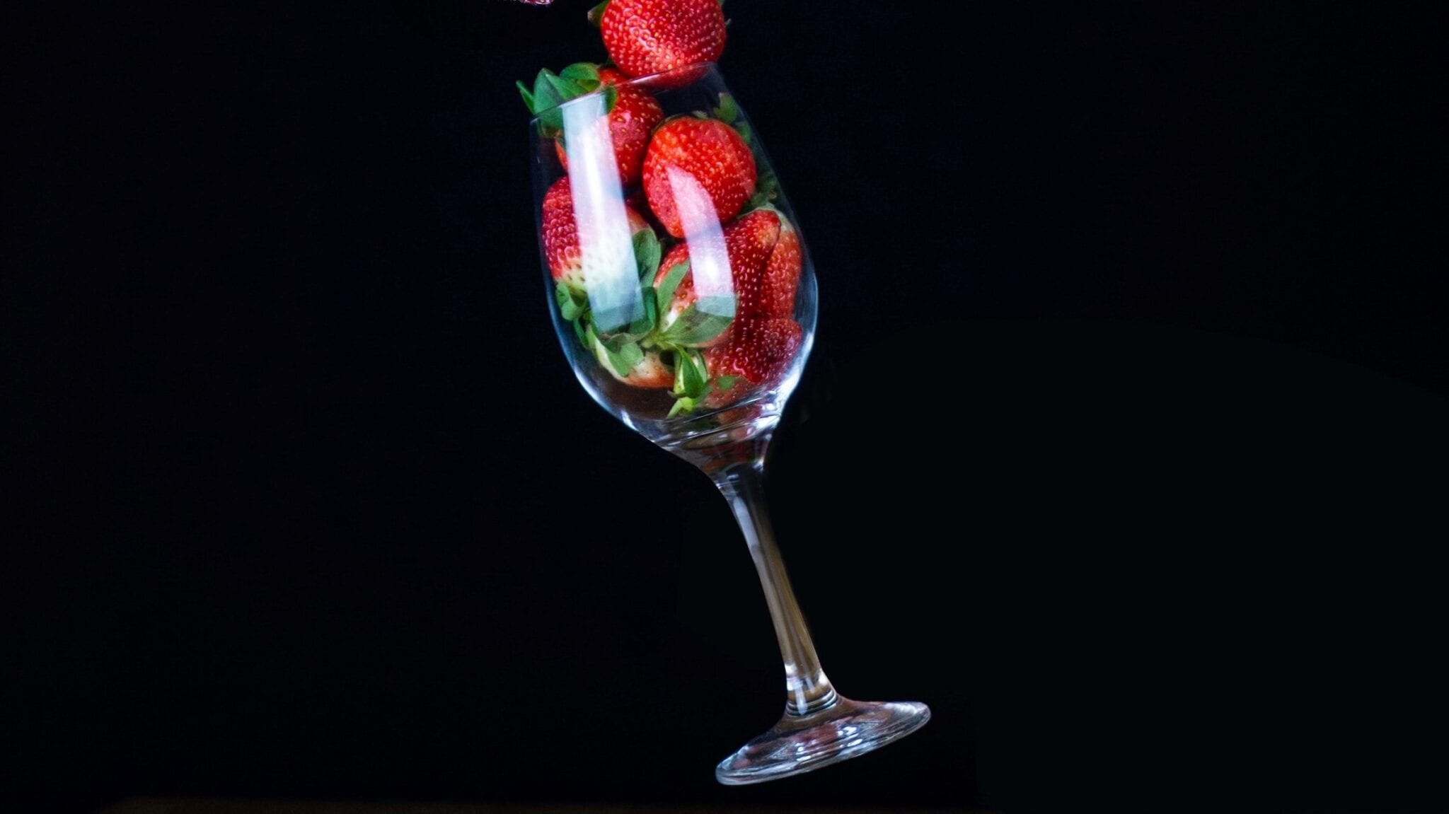 Wine glass with strawberries. Photo by Yulia Matvienko, Unsplash