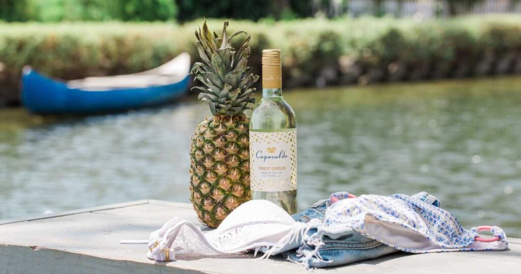 White wine by lake and pineapple