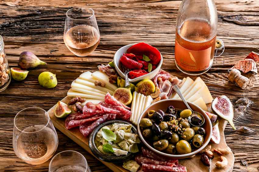 Poema Brut Rose Cava and charcuterie board with meat and cheese