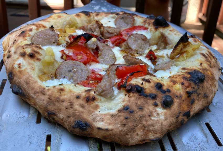 Pizza with sausage, mozzarella, onion, and peppers