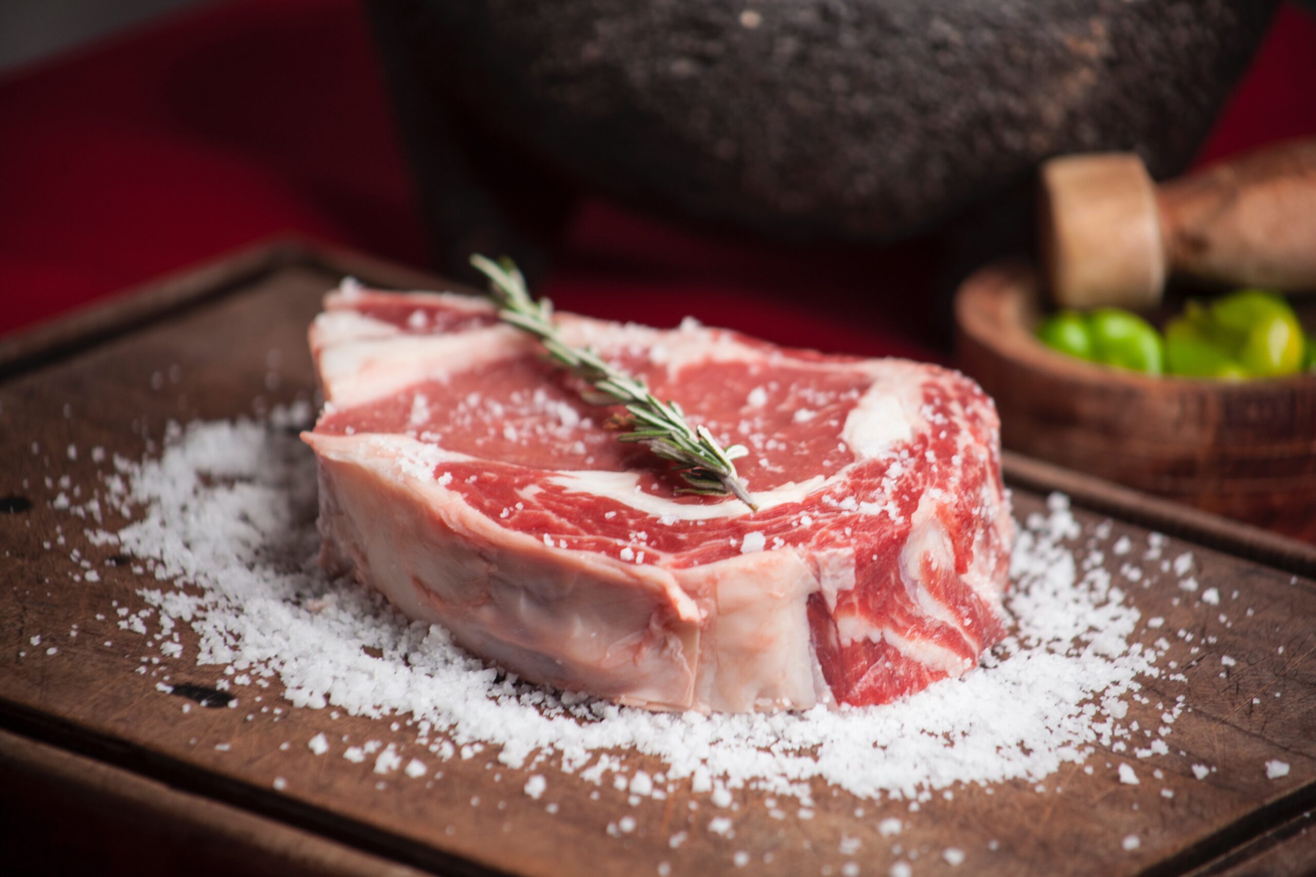Steak marinated in salt with rosemary garnish to pair with lambrusco