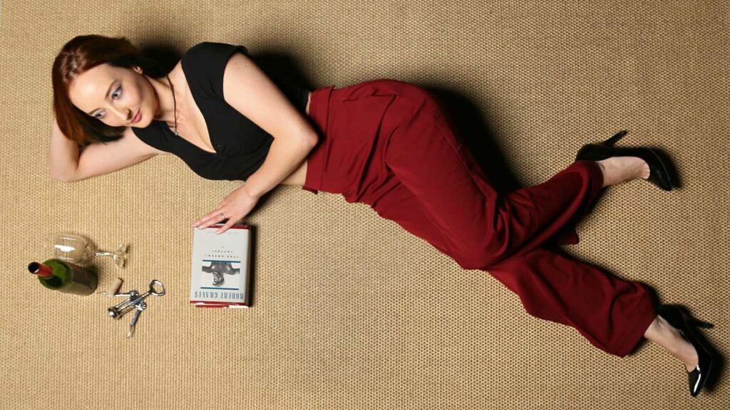 Girl reading book on floor with wine - Steve Rainwater