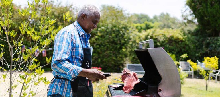 A dad grilling steak on a barbecue grill on father's day