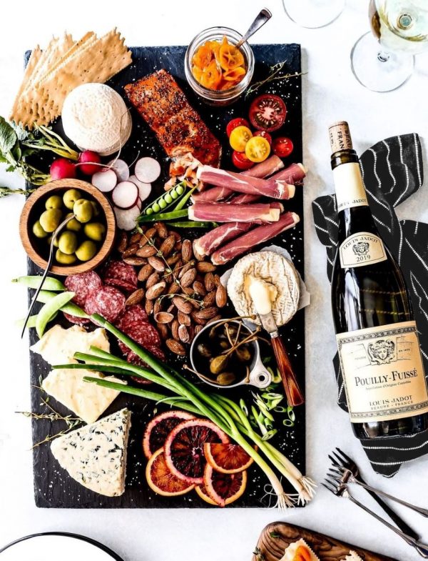 Spectacular charcuterie board with meat, cheese and nuts and Jadot Wine